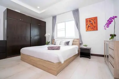 a bedroom with a large bed and a window at 1 bedroom apartment in Nai Harn in Ban Saiyuan (1)