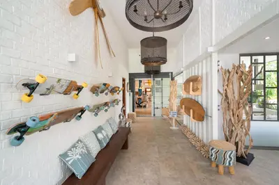 a room with a wall with many different items on it at Contemporary Eden - Villa Jeladore, 5BR, Garden & Pool, near Laguna in Bang Tao Beach