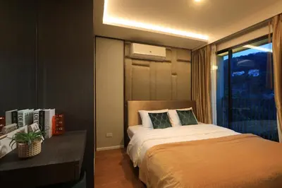 a hotel room with a bed and a window at 3bdr Sea View Apartment Surin Beach by Capital Pro in Phuket Town