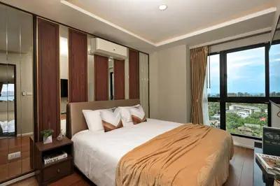 a bedroom with a bed and a large window at 3bdr Sea View Apartment Surin Beach by Capital Pro in Phuket Town