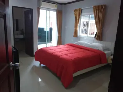 a bedroom with a red bed and a window at Elba Bella Guest House in Patong Beach
