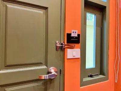 a door with a mirror and a door knob at Sierra Hostel in Nai Yang Beach