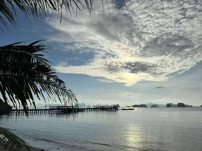 a view of a beach with a pier in the water at Baansuanpiyanan in Ban Bang Chak