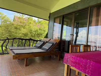a room with a bed on a patio at Phu Samut in Ban Ba Kan Pa