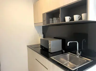 a kitchen with a sink and a microwave at Sea view apartment at Oceana by Lofty in Kamala Beach