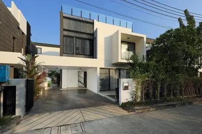 a house with a courtyard in front of it at Laguna Park Grand Villa na Bang Tao in Phuket Town