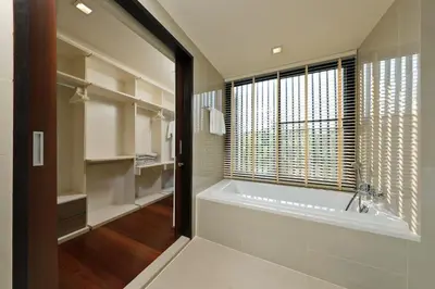 a bathroom with a bath tub and a window at Laguna Park Grand Villa na Bang Tao in Phuket Town