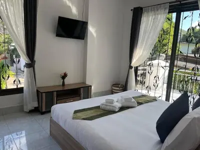 a bedroom with a large bed with towels on it at Kata Sea Blue Villa in Kata Beach