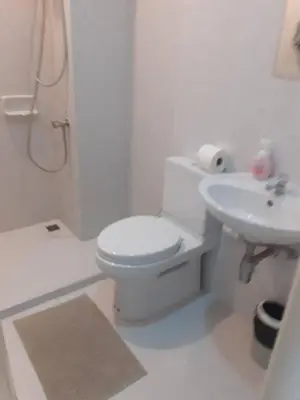 a white bathroom with a toilet and a sink at Zcape 4U in Ban Thalat Choeng Thale