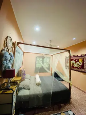 a bedroom with a bed with a canopy at Beachfront bungalow south of Phuket in Phuket Town