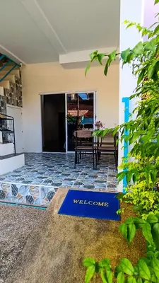 a welcome sign in the front yard of a house at Kata Lina guesthouse in Kata Beach