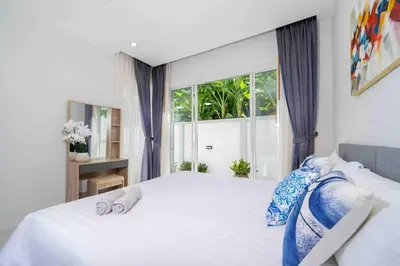 a bedroom with a large bed with two towels on it at Modern Villa , 2-bedroom, Rawai in Ban Saiyuan (1)