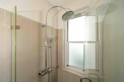 a shower in a bathroom with a window at Modern Villa , 2-bedroom, Rawai in Ban Saiyuan (1)