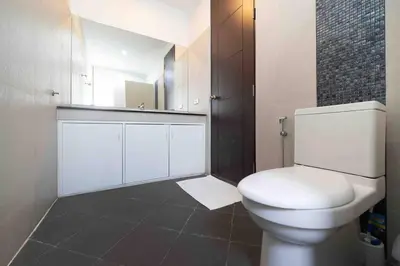a bathroom with a white toilet and a mirror at Modern Villa , 2-bedroom, Rawai in Ban Saiyuan (1)
