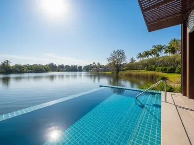 a swimming pool with a view of a lake at ANGSANA Oceanview Apartments with a privat pool in Laguna area in Bang Tao Beach