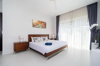 a bedroom with a bed and a large window at Villa in Ravai , 2 bedrooms in Ban Saiyuan (1)