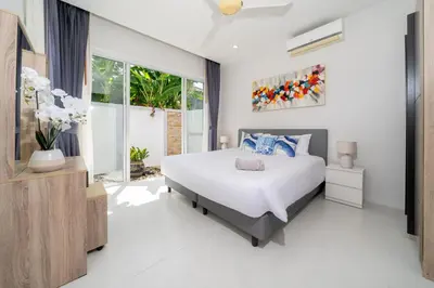 a bedroom with a bed and a large window at Villa in Ravai , 2 bedrooms in Ban Saiyuan (1)