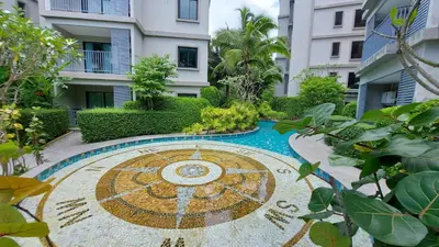 a courtyard with a clock in the middle of a building at Bright Apartment Close to Amazing Beach ! 39 Sqm in Nai Yang Beach