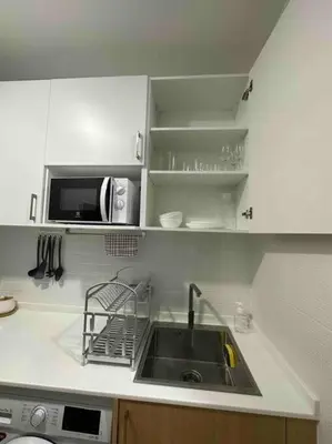 a kitchen with a sink and a microwave at Apartment Karon 62 sq in Karon Beach