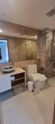a bathroom with a toilet and a sink at Title V in Rawai Beach