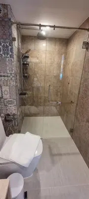 a bathroom with a toilet and a glass shower at Title V in Rawai Beach
