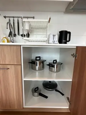 a kitchen with two pots and pans on a shelf at Title V in Rawai Beach
