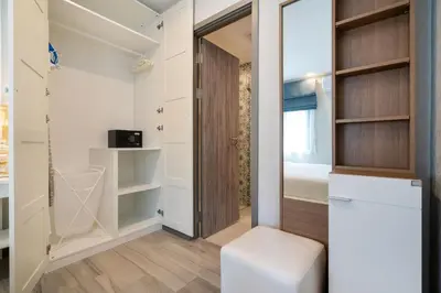 a walk in closet with a door and a stool at F12 Номер Люкс Бассейн Рубль ВАТСАП669З582I976 in Nai Yang Beach