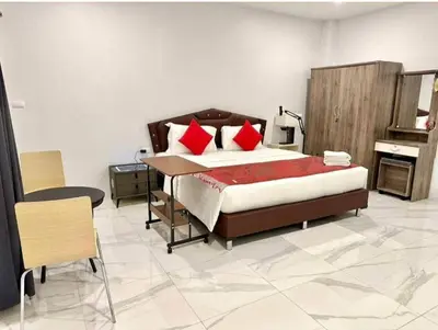 a bedroom with a bed with red pillows and a desk at PR ROOM FOR RENT in Kamala Beach