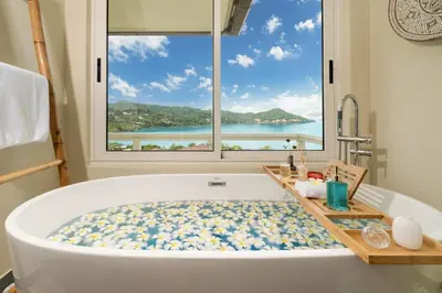 a bath tub in a bathroom with a large window at Stunning 5 bedrooms Villa with Panoramic Sea View in Por Bay