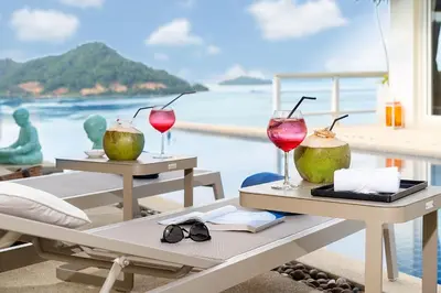 two tables with drinks on them with a view of the ocean at Stunning 5 bedrooms Villa with Panoramic Sea View in Por Bay