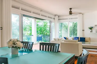 a living room with a blue table and chairs at 3BR Casa Azul - Beachfront Home in Laguna & Layan Chom Tawan and Maan Tawan Residences in Phuket Town