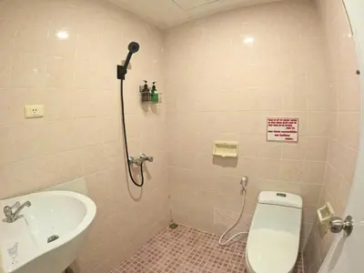 a bathroom with a shower and a toilet and a sink at KPOP Hostel in Karon Beach