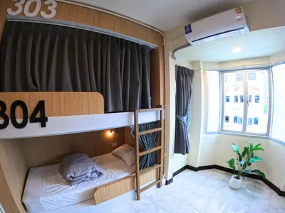 a small room with a bunk bed and a window at KPOP Hostel in Karon Beach