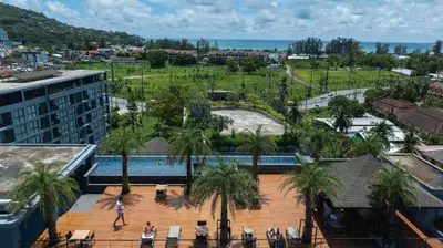 an aerial view of a resort with a pool and palm trees at Modern Condo in Boutique Style Resort CGB4 in Phuket Town