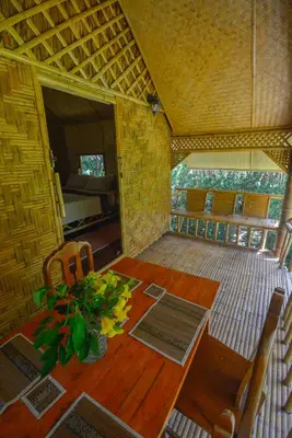 a dining room with a wooden table and chairs at Ratanaporn Green in Phuket Town
