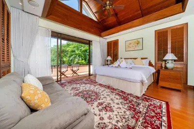 a bedroom with two beds and a couch at Seaview 5BR Pool Villa Apsara, Free Breakfast and Full Service, 5 min walk to Kata Beach in Kata Beach