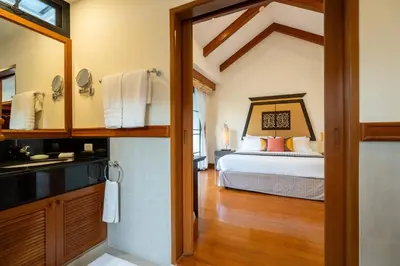 a bathroom with a bed and a sink in a room at Grand 4-Bed Lagoon Villa - Private Pool & Garden - Laguna in Ban Thalat Choeng Thale