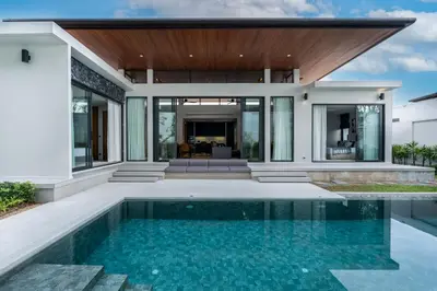 an exterior view of a house with a swimming pool at Space villa Botanica Modern Loft in Ban Pak Lak