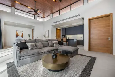 a living room with a couch and a table at Space villa Botanica Modern Loft in Ban Pak Lak