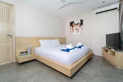 a bedroom with a large bed and a television at Serenity and Modern Art - Open Hill View 3BR Natural Park Villa 1 in Kamala Beach