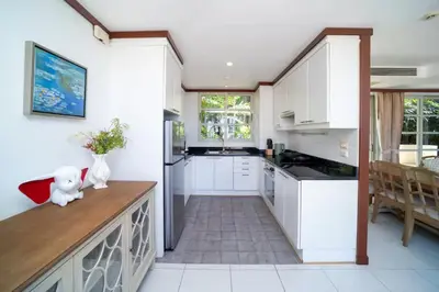 a kitchen with white cabinets and a counter top at Scenic Seaview Villa Sea Dream for 9, Tennis Court, 5min walk to Kata Noi Beach in Kata Beach
