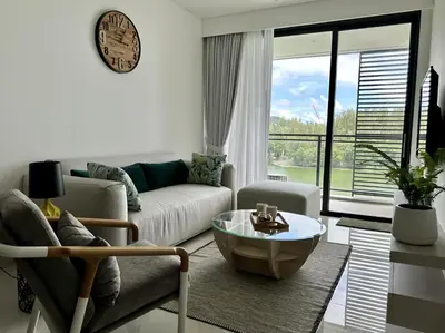a living room with a couch and a coffee table at 2 bedroom Condo at Cassia Laguna in Bang Tao Beach