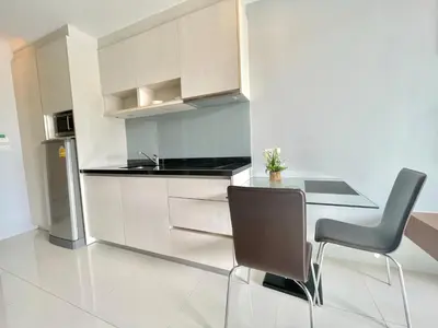 a kitchen with a dining table and two chairs at 1 bedroom near beach - At The Tree in Rawai Beach
