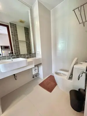 a bathroom with a sink and a toilet and a mirror at 1 bedroom near beach - At The Tree in Rawai Beach