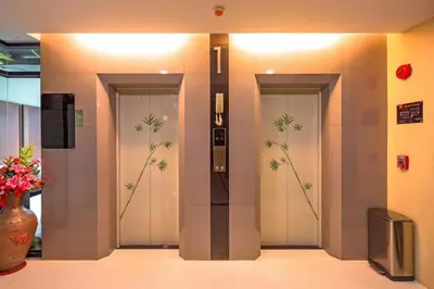 a lobby with three doors with bamboo paintings on them at 1 bedroom near beach - At The Tree in Rawai Beach