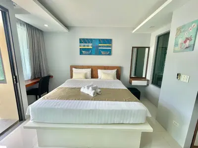 a bedroom with a bed with a stuffed animal on it at 1 bedroom near beach - At The Tree in Rawai Beach
