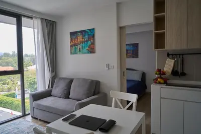 a living room with a couch and a table at Modern 2-bedroom Apartments. Skypark Laguna (Bang Tao) in Bang Tao Beach