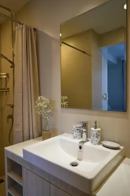 a bathroom with a white sink and a mirror at Modern 2-bedroom Apartments. Skypark Laguna (Bang Tao) in Bang Tao Beach