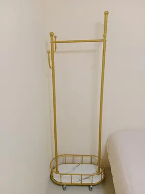 a metal bed rack next to a bed at STP apartment 2rd floor in Patong Beach