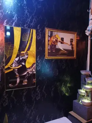 two framed pictures on a wall with a shelf at STP apartment 2rd floor in Patong Beach